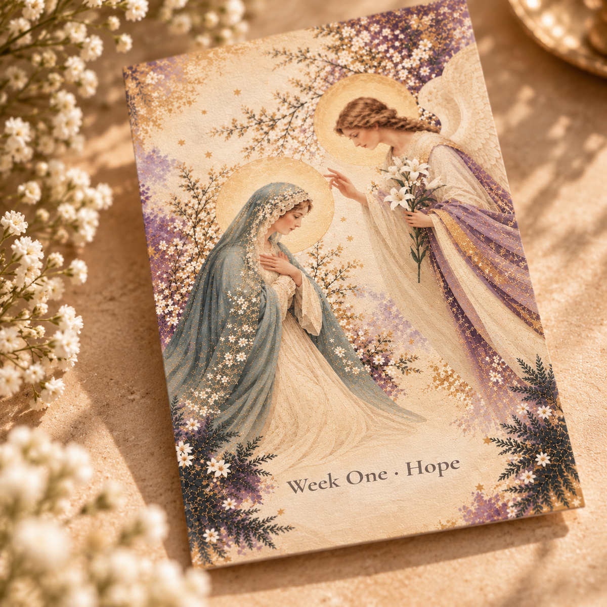 Close-up of the Annunciation artwork: Mary kneeling in a blue veil as the angel Gabriel holds white lilies, in watercolor, gold and Advent purple
