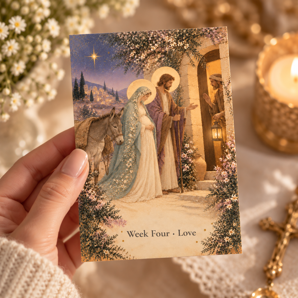 Hand holding a 4x6 Week Four Love Advent prayer card of Mary and Joseph seeking room at the inn by candlelight