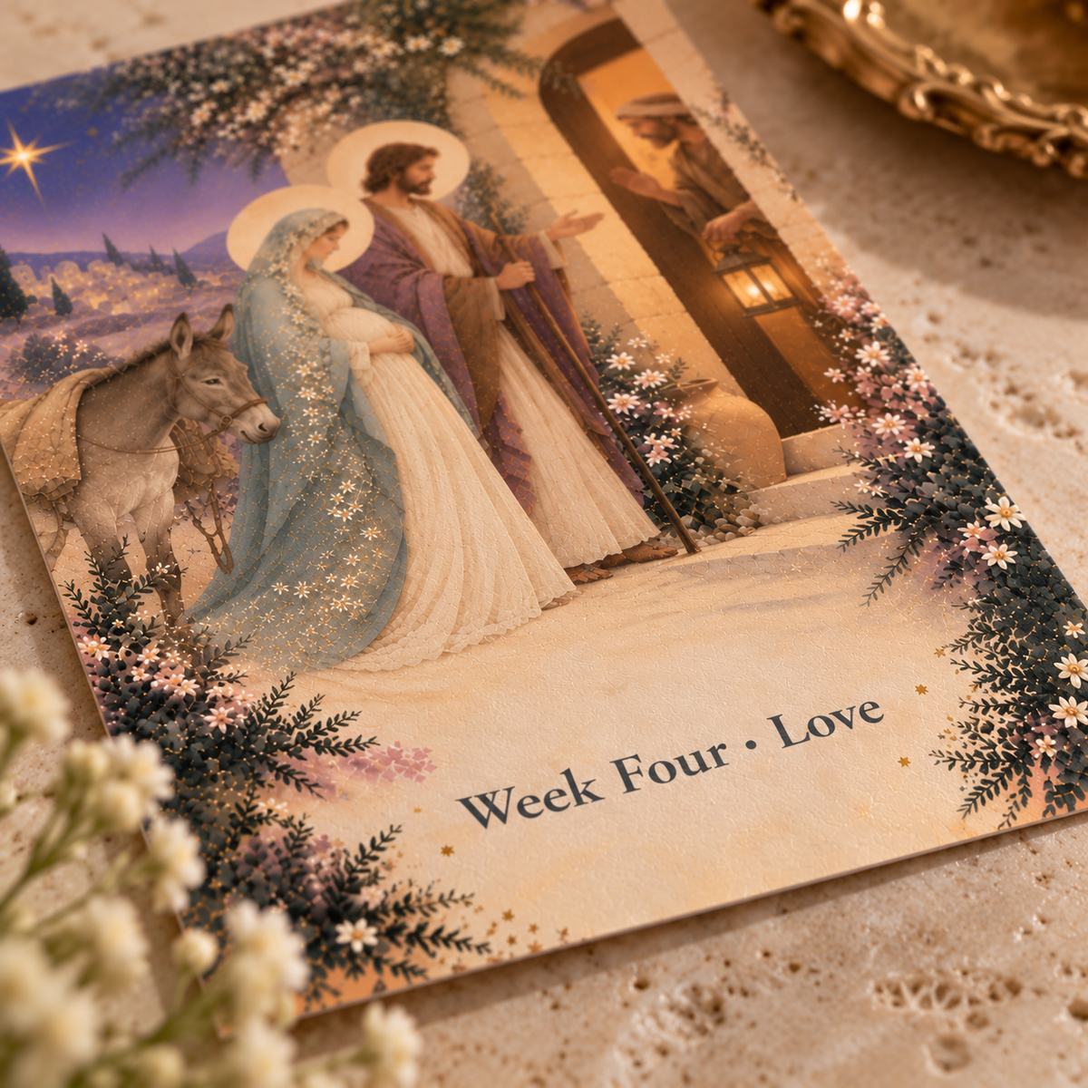 Close-up of the artwork: Mary with the donkey and St. Joseph at the inn door as the innkeeper raises his hand, the star shining over Bethlehem, in watercolor and gold